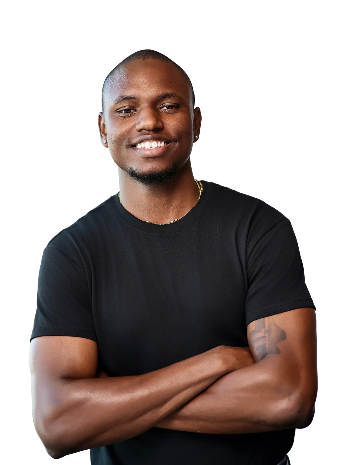 Smiling man in a black tee with arms crossed on a white backdrop