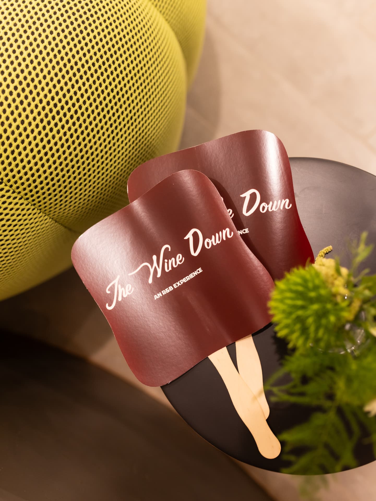 The Wine Down hand fans on a table